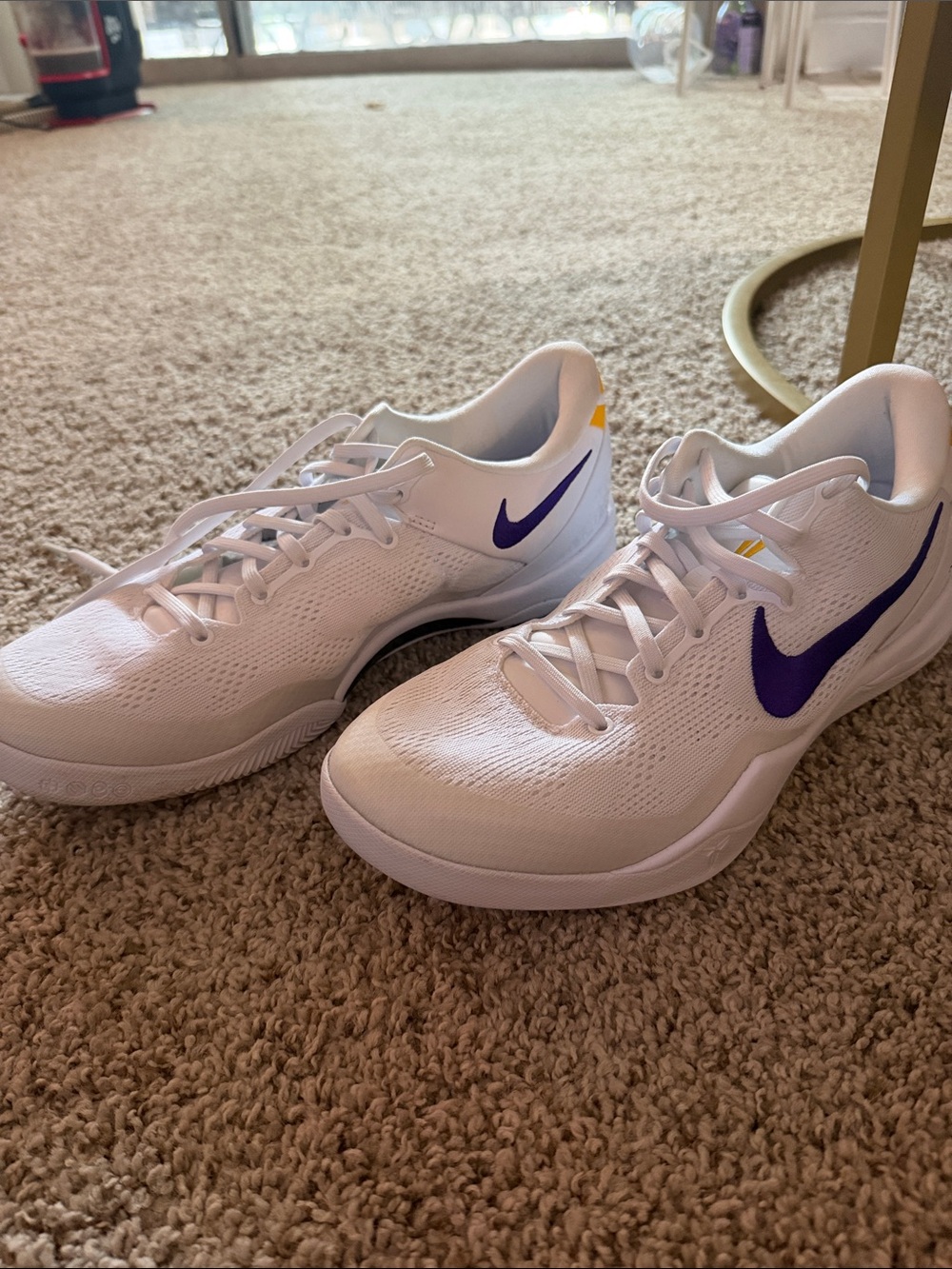 Nike White Athletic Sneakers with Purple Swoosh and Yellow Heel Accent